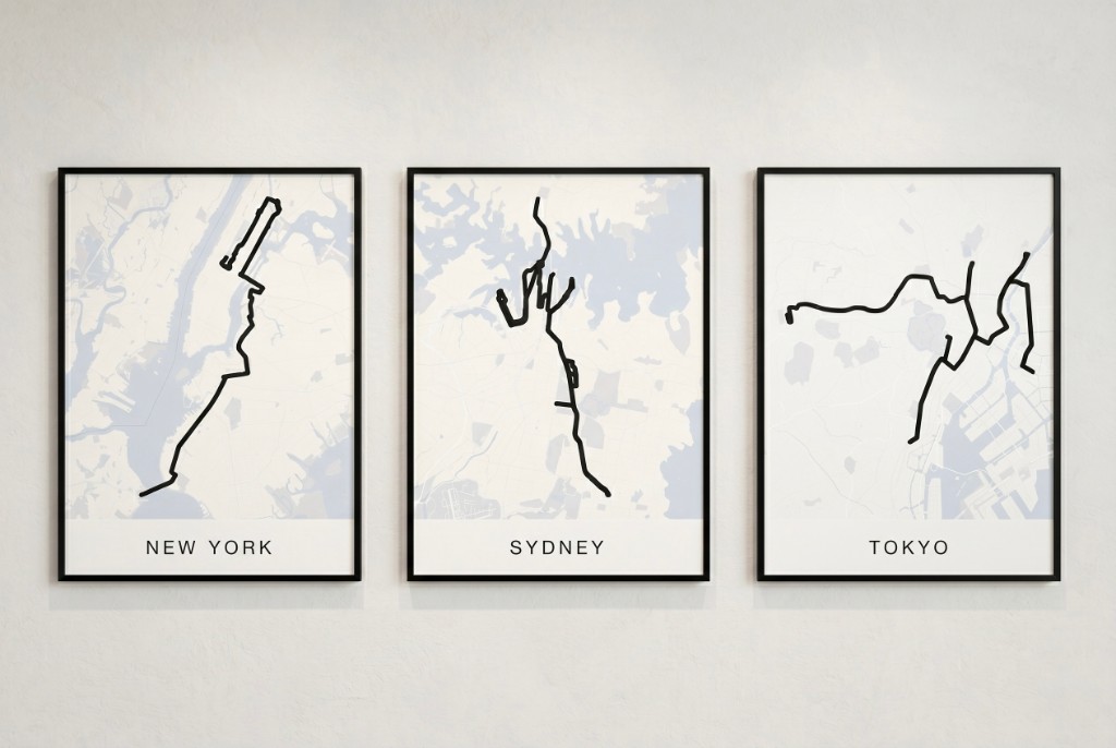 Three framed route posters for New York, Sydney, and Tokyo side by side on a gallery wall
