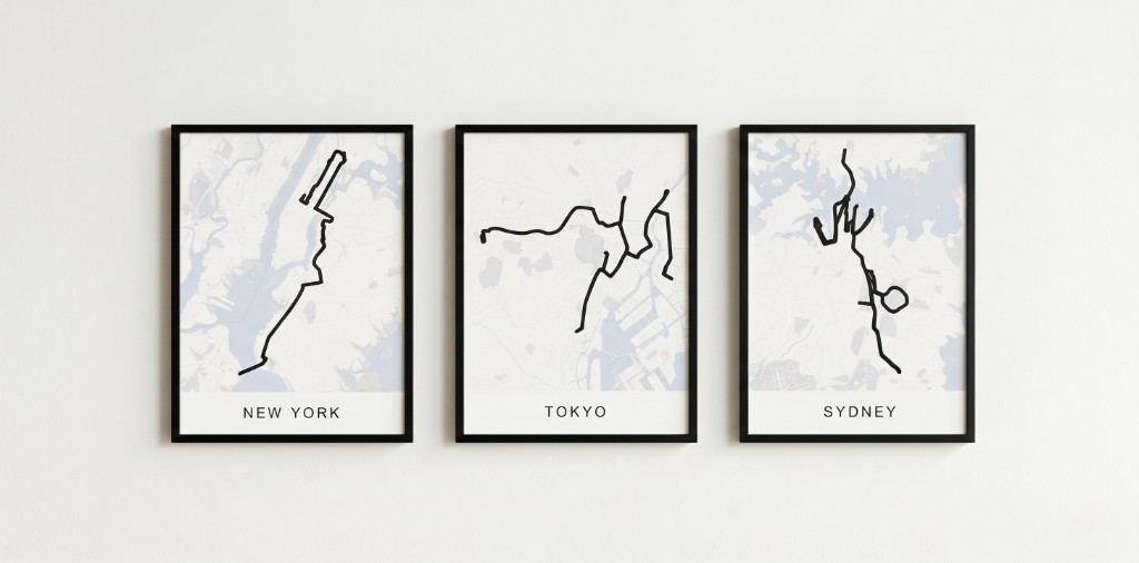 Three framed route posters for New York, Tokyo, and Sydney side by side on a gallery wall